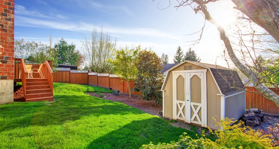 Fenced backyard with storage shed in Bend